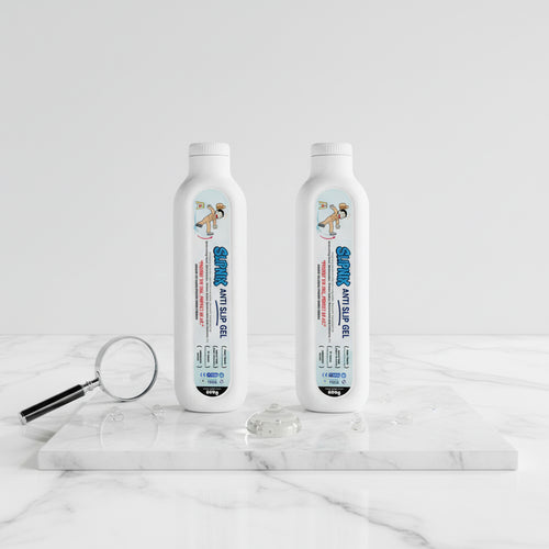 Two bottles of anti-slip gel on marble surface with gel drops and magnifying glass